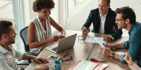 4 mental healthy colleagues sit around a conference room table